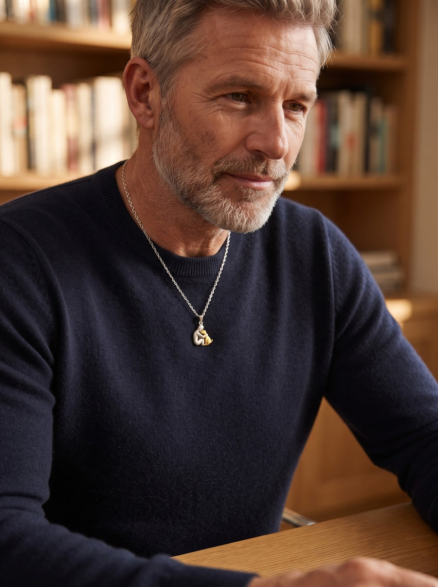 Man wearing the Eternal Hug Necklace at his desk