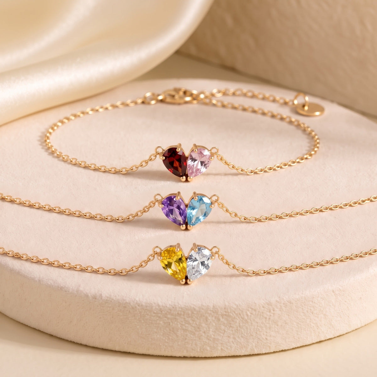 Three gold Elora Bracelets with different birthstone pairs
