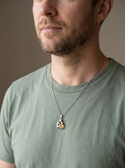 Man wearing the Eternal Hug Necklace over a t-shirt
