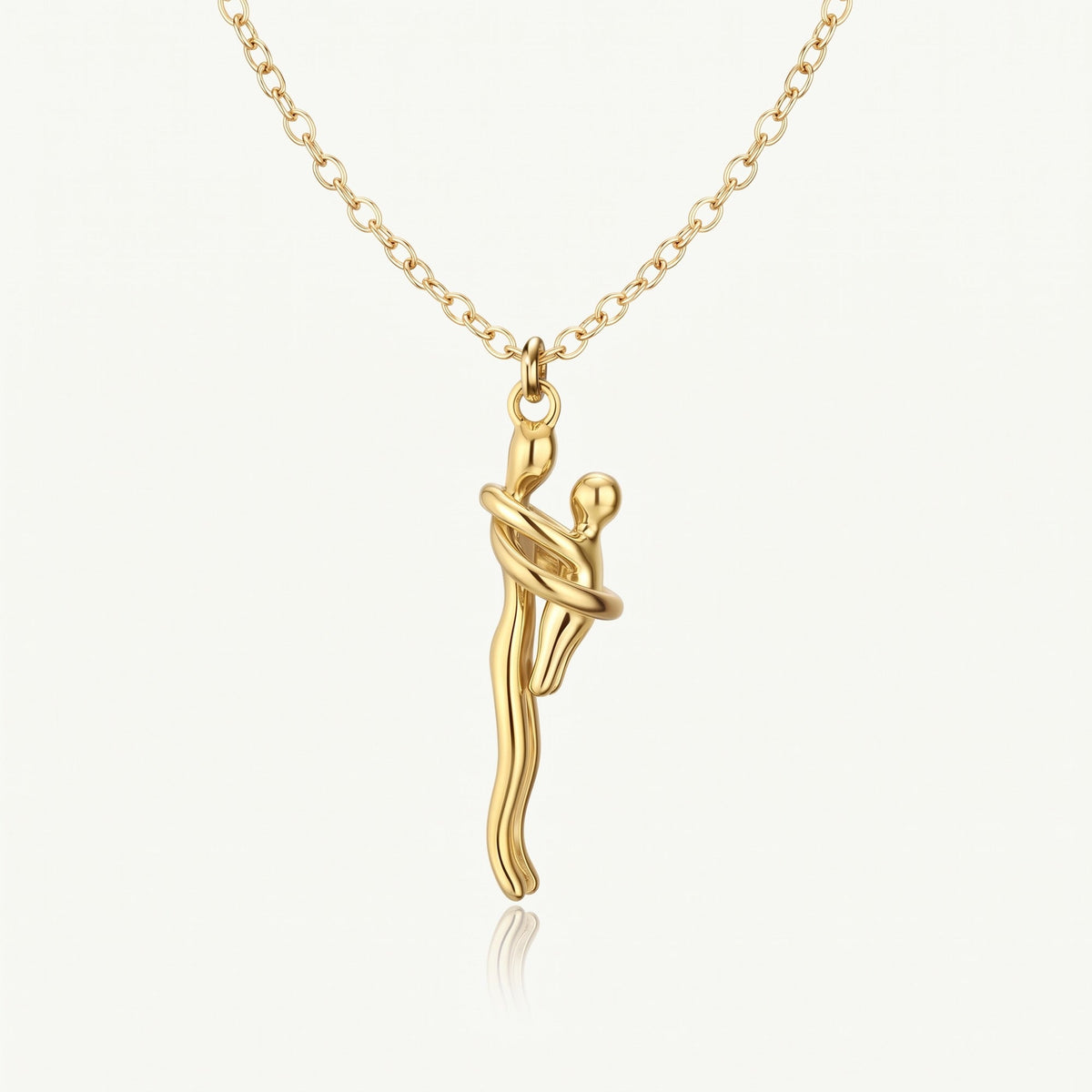 Mother & Child Necklace in full gold, two figures in an embrace