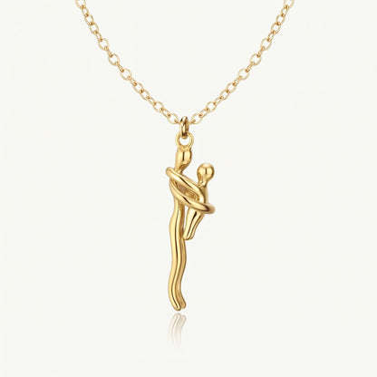 Mother & Child Necklace in full gold, two figures in an embrace