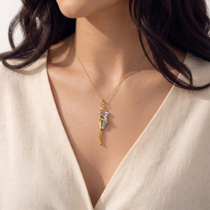 Close-up of the Mother & Child pendant in gold and silver